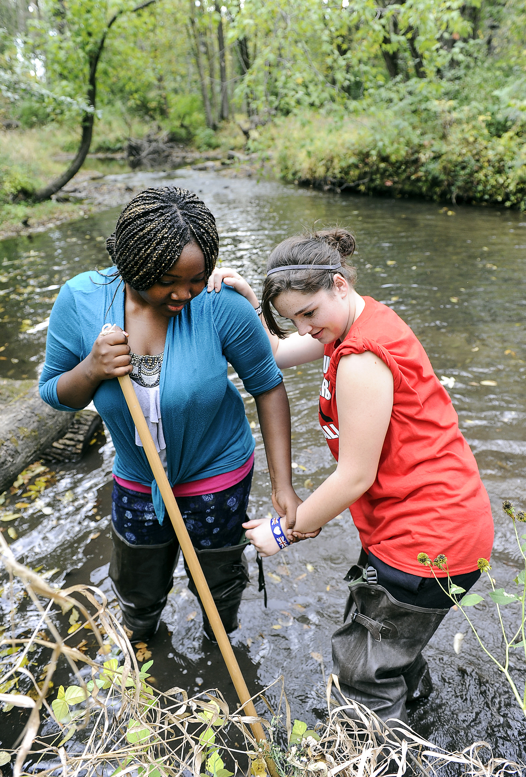 Mamafe Kromah holds a net as Lexi Shafer pokes around the bank of Dobbins Creek looking for critters during an Ellis seventh-grade all-day ecology field trip to the Jay C. Nature Center Friday afternoon. Eric Johnson/photodesk@austindailyherald.com
